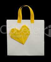 white shopping bag with yellow heart.