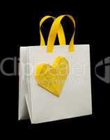 white shopping bag with yellow heart.