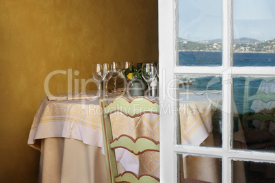 arranged table in a restaurant and open window