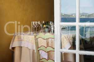 arranged table in a restaurant and open window