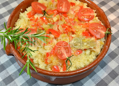Couscous with vegetables in clay dish
