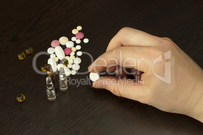 drugs and hand holding pill