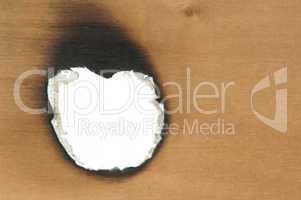 Burned wooden paper and hole