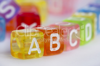 Text A B C on colorful wooden cubes