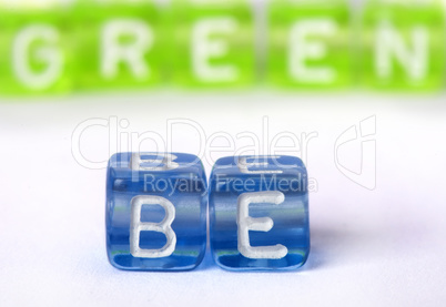 Text Be green on colorful cubes