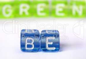 Text Be green on colorful cubes