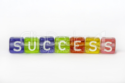 Text success on colorful wooden cubes