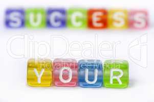 Text Your success on colorful wooden cubes