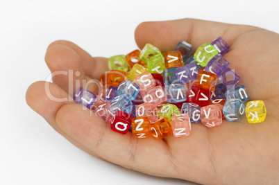 Children hand holding cubes with letters