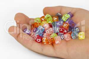 Children hand holding cubes with letters