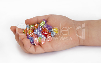 Children hand holding cubes with letters