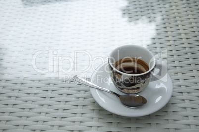 Cup of coffee on white table.