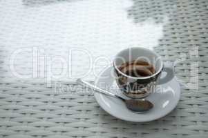 Cup of coffee on white table.