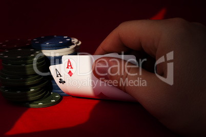 Two aces high on red table with chips