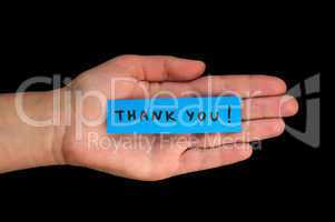 Frase Thank You on paper and hand