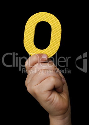Children hand holding the number Zero