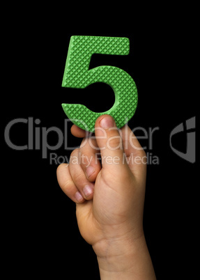 Children hand holding the number Five