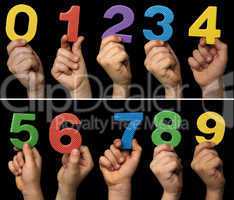 Children hands holding numbers. Black isolated multicolor number