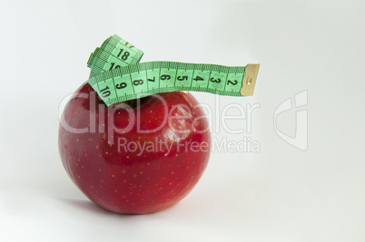 Green tape Measure with red Apple