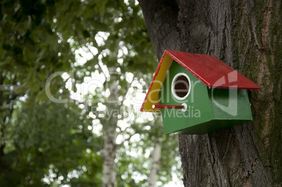 Home-made bright colored bird house