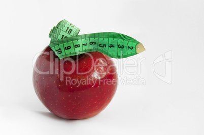 Green tape Measure with red Apple