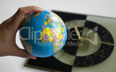 Globe and watch on background