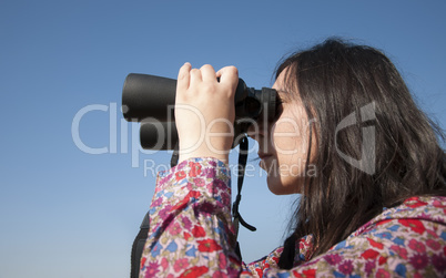 Young woman using binoculars