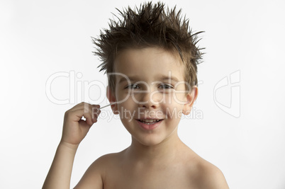 Boy cleans his ear
