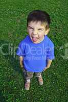 Young boy tongue sticking
