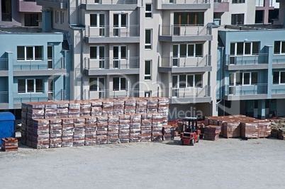 Pallets of bricks in front of new building