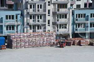 Pallets of bricks in front of new building