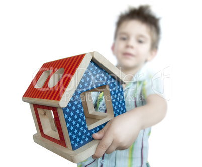 Boy presenting wood colorful house toy