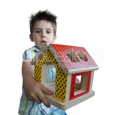 Boy presenting wood colorful house toy