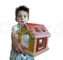 Boy presenting wood colorful house toy