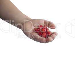 Children's hand with wild strawberries