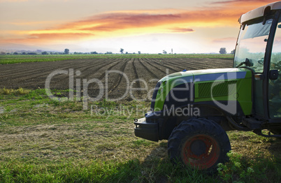 Plowed land and tractor