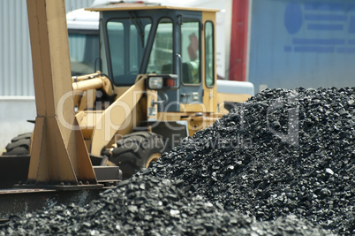 Excavator and coal piles