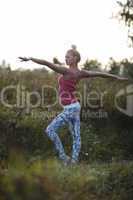 young ballerina or gymnast practising in the park