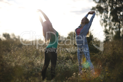 two young women working out in the garden