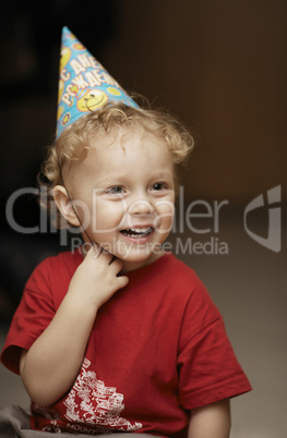 cute happy young boy in a party hat