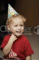 cute happy young boy in a party hat