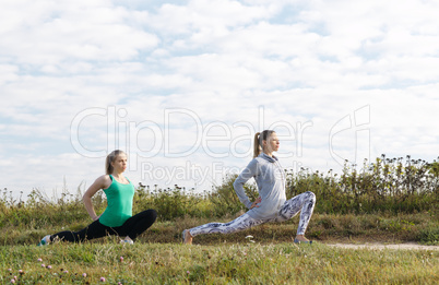 two young girls exercising outdoors