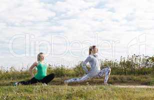 two young girls exercising outdoors