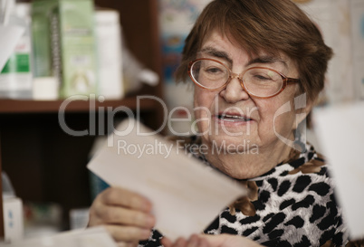 elderly woman reading a letter