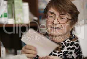 elderly woman reading a letter