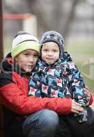 two adorable young brothers outdoors in winter