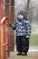 cute little boy dressed in trendy winter clothes