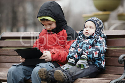 brothers with tablet computer