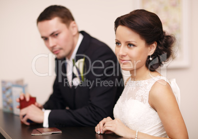 couple at a reception desk with their passports