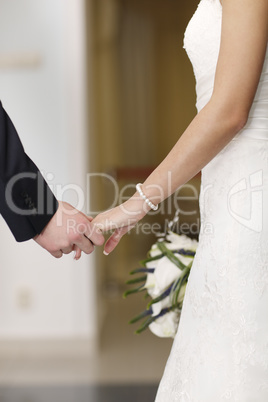 bride and groom holding hands